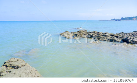 Calm Tropical Seascape with a Distant Coastline 131099764