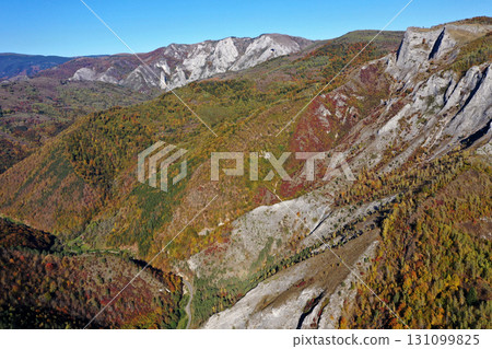 Aerial view of rocky limestone mountains and autumn forest 131099825
