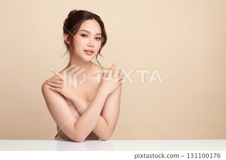 A beautiful young Asian woman with clean, fresh skin against a beige background. Skincare, facial treatment, cosmetology, beauty, and spa. An elegant portrait of an Asian woman. A beautiful young Asian woman with clean, fresh skin against a beige background. Skincare, facial treatment, cosmetology, beauty, and spa. An elegant portrait of an Asian woman. 131100176