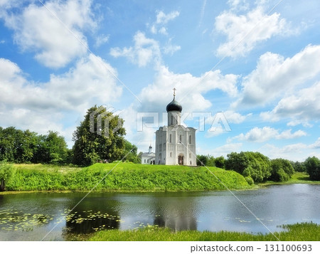 An ancient Christian Orthodox church stands against a blue sky backdrop. 131100693