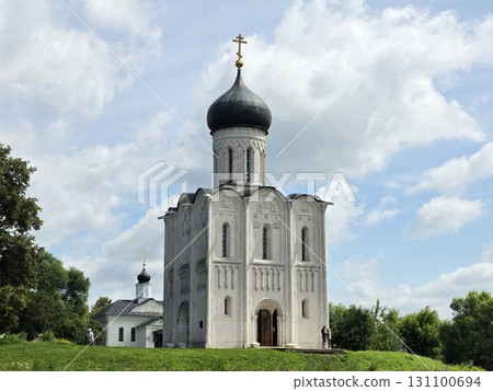 An ancient Christian Orthodox church stands against a blue sky backdrop. 131100694