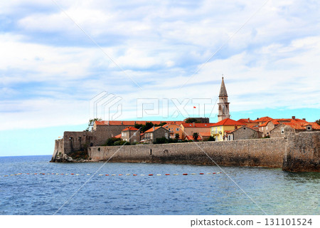 Old town, fortress wall and Adriatic sea, Budva, Montenegro. Beautiful scene with medieval houses and seascape. Topic of summer vacation, travel, cruises and tours 131101524