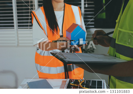 Closeup of team of industrial engineers meeting analyze machinery blueprints consult project on table in manufacturing factory. Working in manufacturing plant or production plant. 131101883
