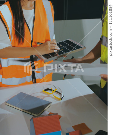 Closeup of team of industrial engineers meeting analyze machinery blueprints consult project on table in manufacturing factory. Working in manufacturing plant or production plant. 131101884