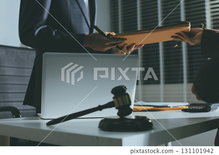 Lawyer explained to the client about the law that must be brought against the court case. Lawyer explained to the client about the law that must be brought against the court case. 131101942
