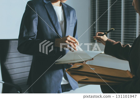 Lawyer explained to the client about the law that must be brought against the court case. Lawyer explained to the client about the law that must be brought against the court case. 131101947
