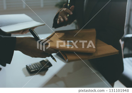 Lawyer explained to the client about the law that must be brought against the court case. Lawyer explained to the client about the law that must be brought against the court case. 131101948