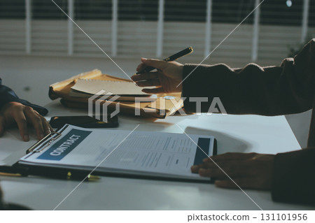 Lawyer explained to the client about the law that must be brought against the court case. Lawyer explained to the client about the law that must be brought against the court case. 131101956