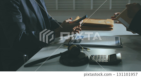 Lawyer explained to the client about the law that must be brought against the court case. Lawyer explained to the client about the law that must be brought against the court case. 131101957