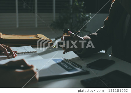 Lawyer explained to the client about the law that must be brought against the court case. Lawyer explained to the client about the law that must be brought against the court case. 131101962