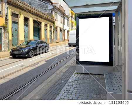 Billboard mockup at bus stop in old city street with blank vertical frame for advertising, 131103405