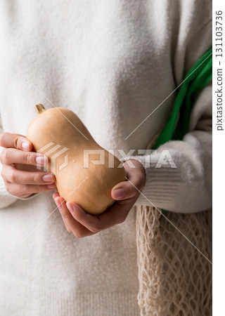 Butternut squash pumpkin holding by woman hand Butternut squash pumpkin holding by woman hand 131103736
