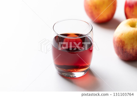 Glass of apple cider with red apple fruit on white background Glass of apple cider with red apple fruit on white background 131103764