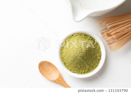 Top view of matcha green tea powder with wooden spoon, bamboo whisk and Chawan bowl Top view of matcha green tea powder with wooden spoon, bamboo whisk and Chawan bowl 131103790