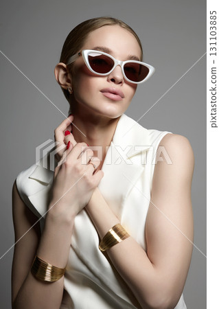 pretty blond girl in glasses and jewelry 131103885