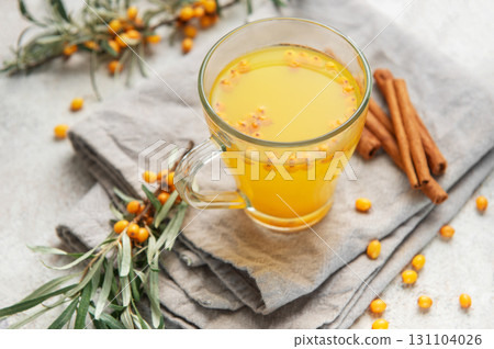 Sea buckthorn hot drink with cinnamon sticks and berries 131104026