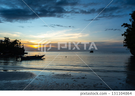 Sunset with pirogue at Lia Beach, Waleakodi Island, Togian archipelago, Indonesia Sunset with pirogue at Lia Beach, Waleakodi Island, Togian archipelago, Indonesia 131104864