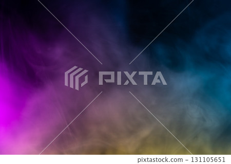 Colorful smoke or fog on dark background with gradient effect, abstract texture in purple, blue, yellow tones, concept of fantasy, atmosphere, and art design. 131105651