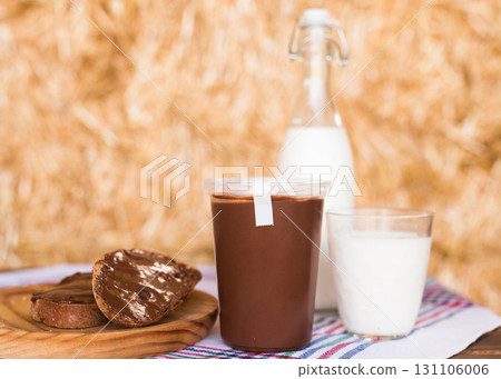 wheat bread with nut butter and a glass of milk on the hay 131106006