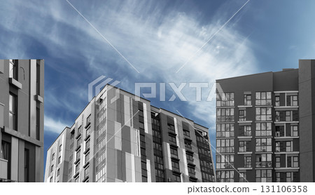 Apartment block in urban district. Multistorey gray building with glass windows and geometric Apartment block in urban district. Multistorey gray building with glass windows and geometric 131106358