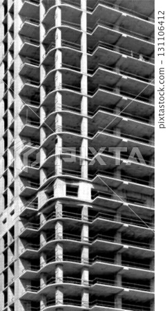 Construction of high rise tower. Exposed concrete framework with rough pattern, balconies, and Construction of high rise tower. Exposed concrete framework with rough pattern, balconies, and 131106412