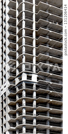 Construction of modern skyscraper. Tall condominium with geometric framework and balconies, 131106414