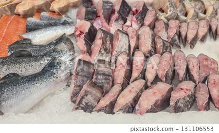 Frozen sea and freshwater fish on a supermarket shelf Sliced and whole Seafood Frozen sea and freshwater fish on a supermarket shelf Sliced and whole Seafood 131106553