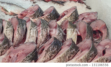 Frozen sea and freshwater fish on a supermarket shelf Sliced and whole Seafood Frozen sea and freshwater fish on a supermarket shelf Sliced and whole Seafood 131106556