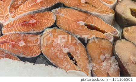 Frozen sea and freshwater fish on a supermarket shelf Sliced and whole Seafood 131106561