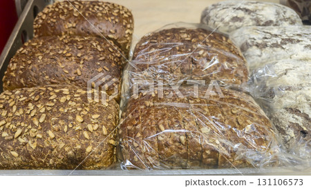 Bread and rolls on display at the store. Freshly baked goods for sale. 131106573