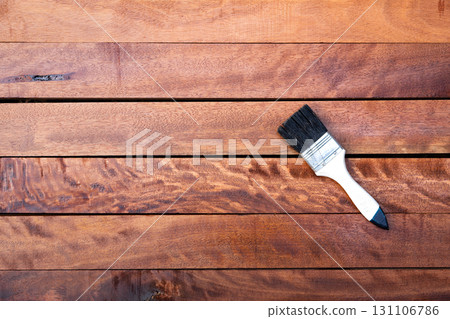 Paint brush and wood material in construction work. 131106786