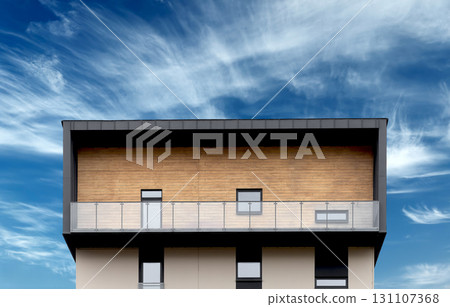 Penthouse with balcony. Modern upper floor apartment with wooden facade, glass windows, minimal Penthouse with balcony. Modern upper floor apartment with wooden facade, glass windows, minimal 131107368