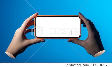 Phone in both hands. Woman holding smartphone with blank screen, finger touching display, blue light Phone in both hands. Woman holding smartphone with blank screen, finger touching display, blue light 131107370