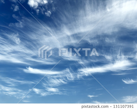 Sky with cirrus clouds. Wispy feather-like vapor formations in bright blue atmosphere, soft layered 131107391