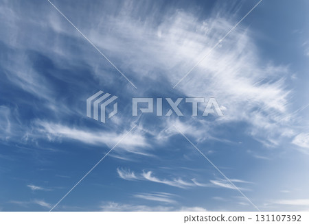 Sky with cirrus clouds. Wispy white streaks in blue atmosphere, soft daylight cloudscape with calm 131107392