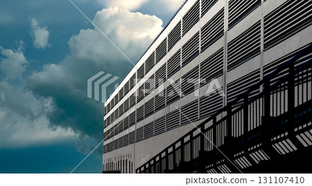 Ventilation facade on cloudy day. Modern architectural wall with metal slats, louver panels, 131107410