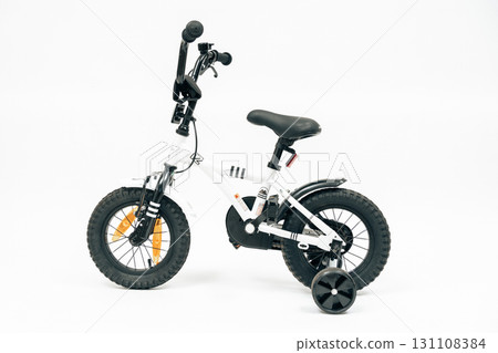 Isolated white kids cycle designed for beginners. Ideal stock for online shops, parenting promotion and lifestyle visuals 131108384