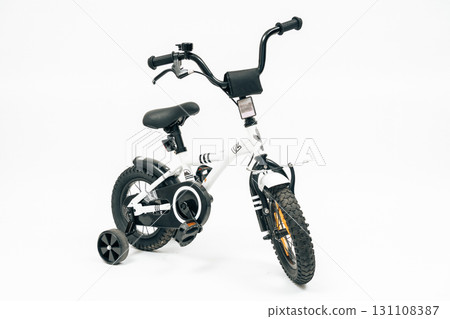 Isolated kids bike photographed for e-commerce and design. Great stock for branding, family lifestyle campaigns and transport product promotion Isolated kids bike photographed for e-commerce and design. Great stock for branding, family lifestyle campaigns and transport product promotion 131108387