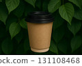 Brown paper coffee cup with black lid against lush green leaves, eco-friendly takeaway beverage concept 131108468