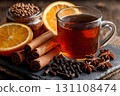 A glass mug of spiced black tea, infused with cinnamon, cloves, anise, and orange slices 131108474
