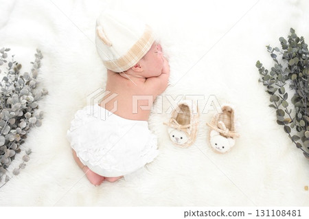 One month after birth, a newborn photo of an innocent sleeping baby lying face down with his arm as his head 131108481