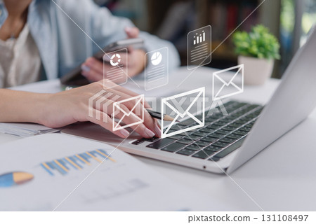 Email communication and digital marketing concept.businesswoman typing on laptop with email and document.Online office workflow with data report charts, digital files, and wireless messaging Email communication and digital marketing concept.businesswoman typing on laptop with email and document.Online office workflow with data report charts, digital files, and wireless messaging 131108497