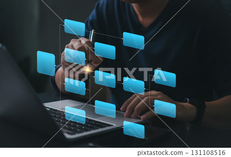 Workflow diagram overlay on laptop screen. Business process mapping and data structure visualization. Man working with digital flowchart interface. Smart planning, project task management 131108516