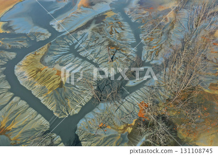 Aerial view of colorful contaminated cyanide residuals waters from gold mine. Abstract nature pattern Aerial view of colorful contaminated cyanide residuals waters from gold mine. Abstract nature pattern 131108745