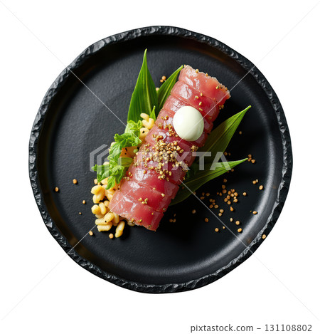 Diced Yellowfin Tuna Tartare Shaped into a Cylinder with Avocado and Nori Crisps on a Black Plate Diced Yellowfin Tuna Tartare Shaped into a Cylinder with Avocado and Nori Crisps on a Black Plate 131108802