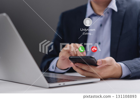 Close-up of a smartphone showing an incoming call from an unknown number. Perfect for office communication, digital communication, and mobile business use visuals. 131108893