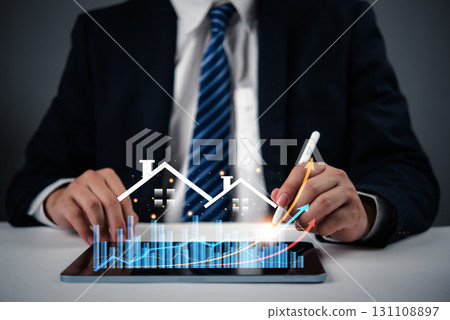 Businessperson analyzing real estate market growth and property data. Great for property investment, real estate market analysis, and business development in housing. 131108897