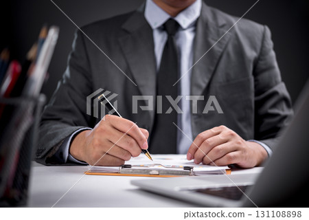 Close-up of business professional writing strategy on document. Perfect for business planning, leadership, corporate decision-making, and business development concepts. Close-up of business professional writing strategy on document. Perfect for business planning, leadership, corporate decision-making, and business development concepts. 131108898