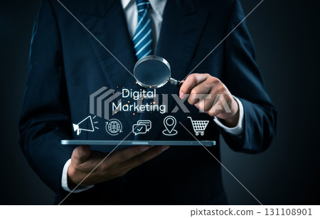 Businessman reviewing digital marketing strategy on tablet with icons. Perfect for digital marketing, ecommerce, online SEO advertising, and social media strategy. 131108901