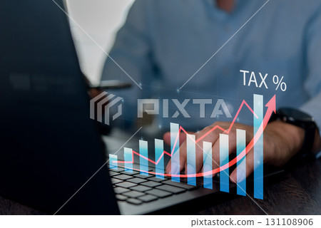 Finance professional analyzing tax data and growth chart on laptop. Great for business analytics, investment planning, financial forecasting, and tax strategy. 131108906